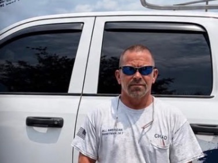 Chad Risker, owner of All American Handyman 24/7, at his work truck